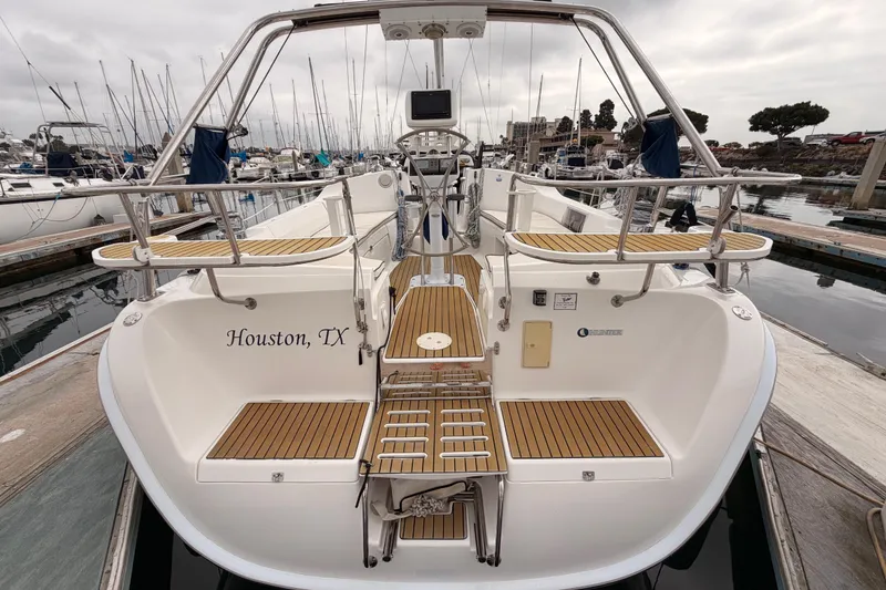 Slide: The Image of 2009 Hunter 38 sailboat docked in marina, Houston, TX, with teak deck accents. - 5