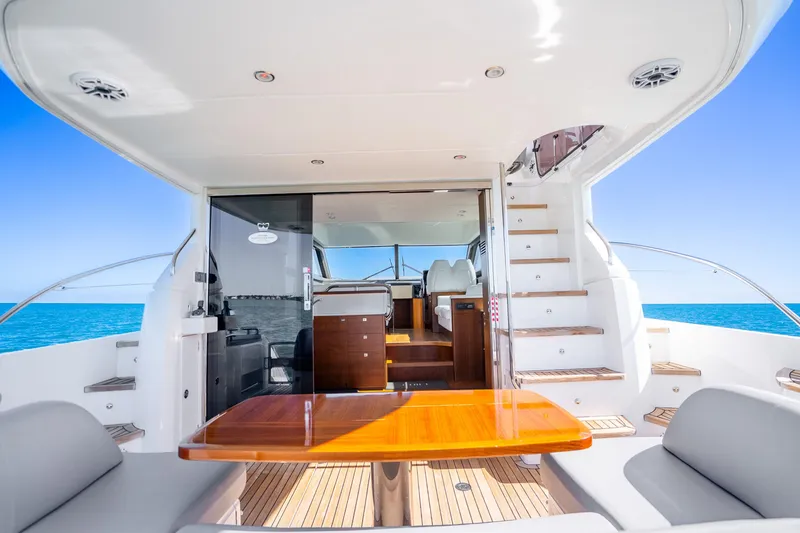 Slide: The Image of Luxurious 2018 Princess F49 yacht interior with wooden table, ocean view, and modern seating. - 42