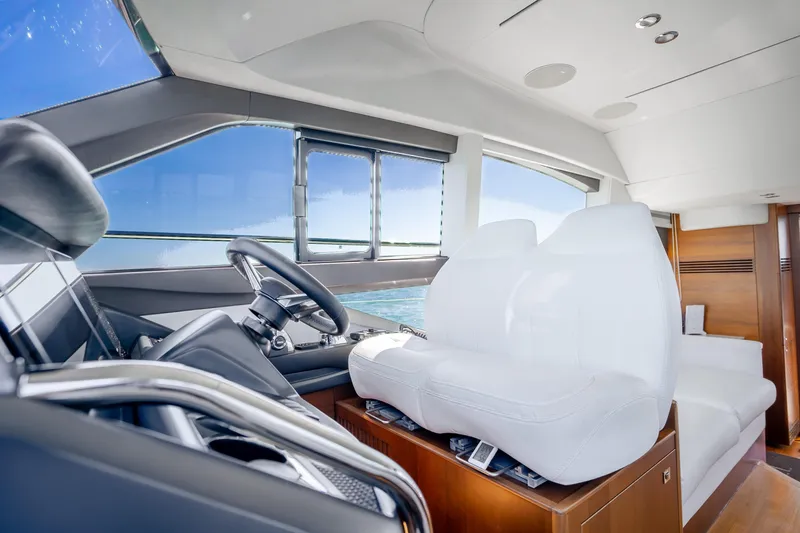 Slide: The Image of Luxurious 2018 Princess F49 yacht interior with sleek helm and plush white seating. - 21