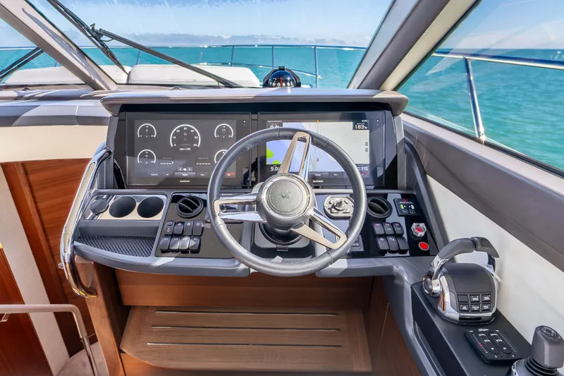 Slide: The Image of Cockpit of 2018 Princess F49 yacht with modern navigation controls and steering wheel. - 18