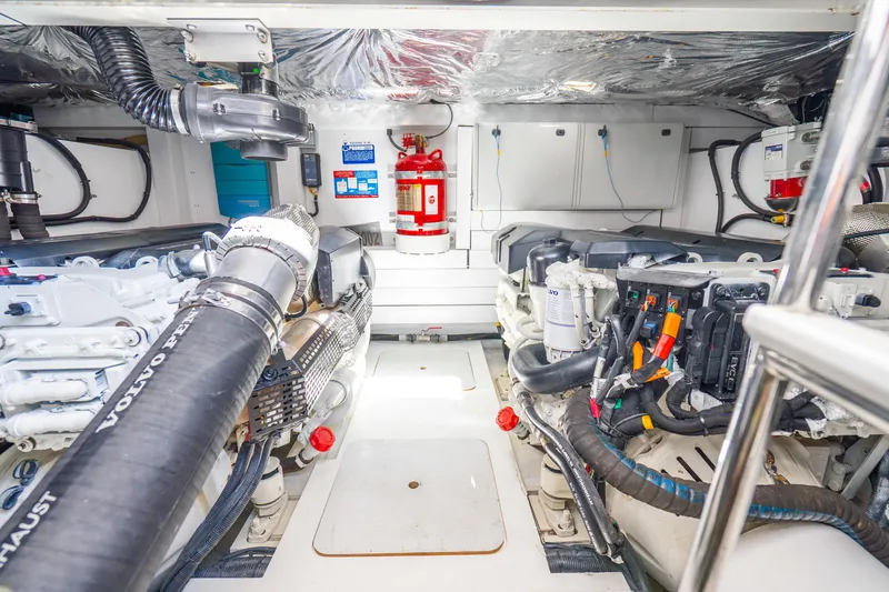 Slide: The Image of Engine room of a 2018 Princess F49 yacht, featuring Volvo Penta components and fire safety equipment. - 56