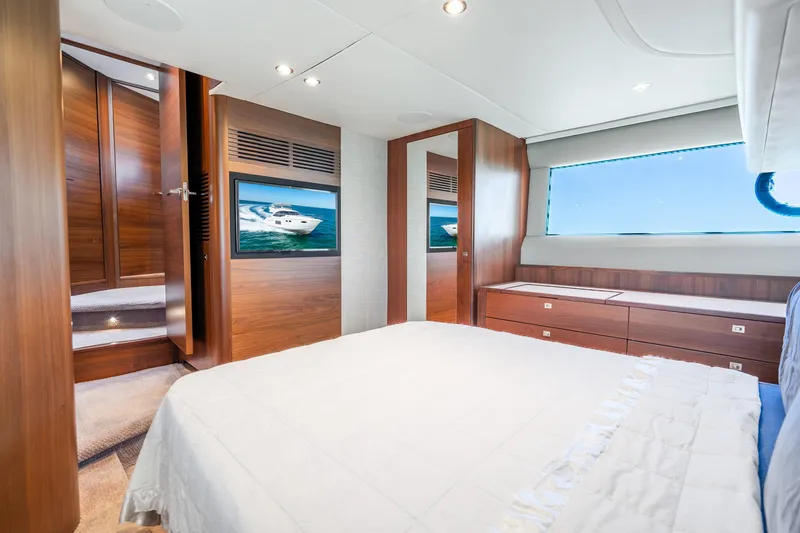 Slide: The Image of Luxurious 2018 Princess F49 yacht bedroom with wood accents and ocean view. - 31