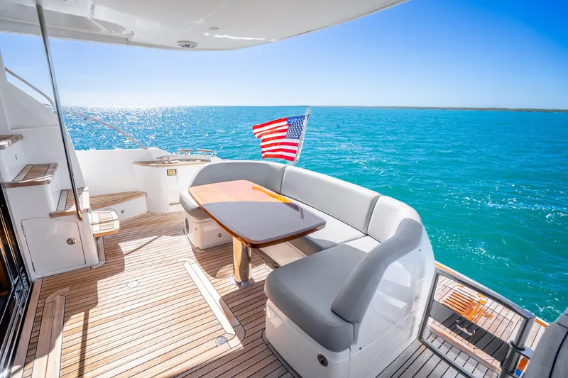 Slide: The Image of Luxurious 2018 Princess F49 yacht deck with seating, ocean view, and American flag. - 43