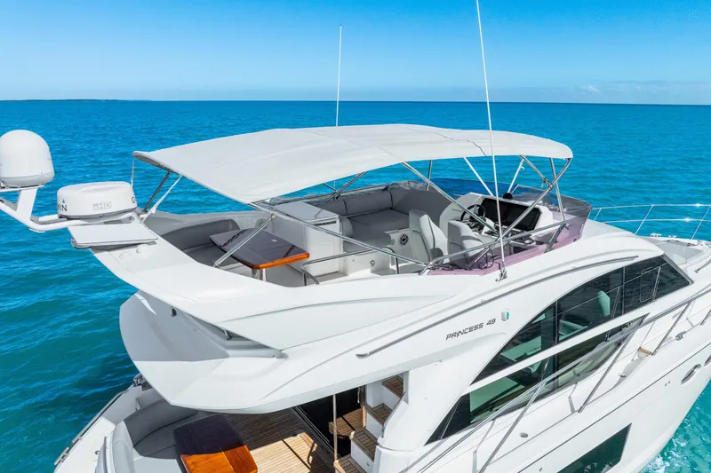 Slide: The Image of Luxury 2018 Princess F49 yacht cruising on clear blue ocean waters. - 16