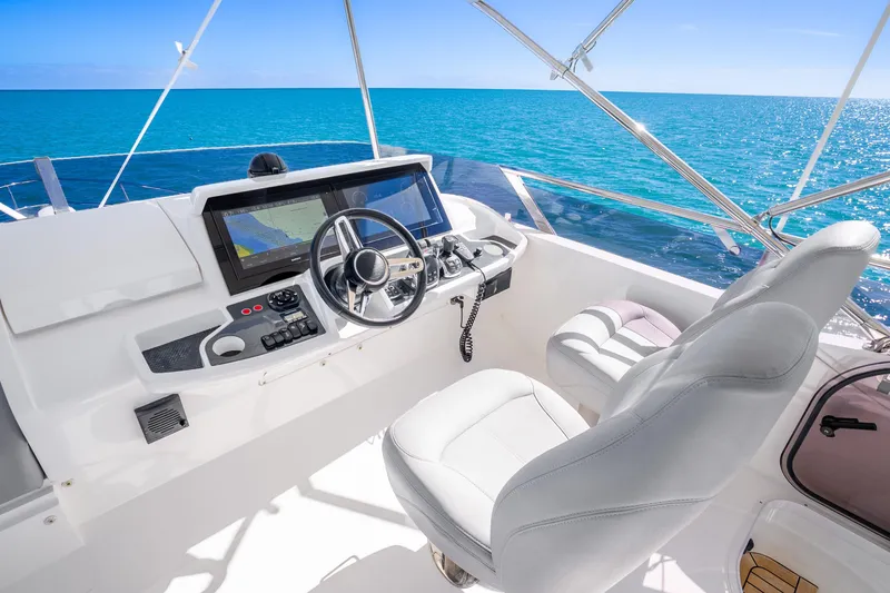 Slide: The Image of Helm of 2018 Princess F49 yacht with ocean view, featuring modern navigation equipment. - 50