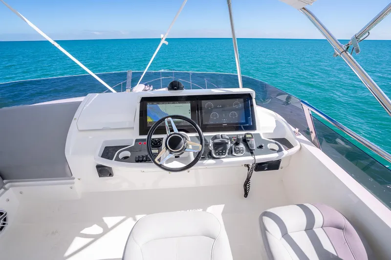 Slide: The Image of Helm of 2018 Princess F49 yacht with ocean view and modern navigation controls. - 51