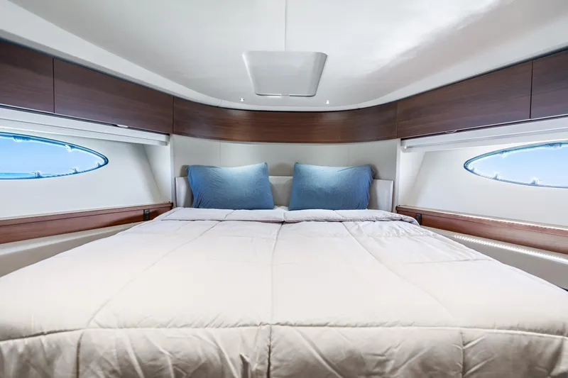 Slide: The Image of Luxurious cabin interior of 2018 Princess F49 yacht with cozy bedding and elegant wood finishes. - 35