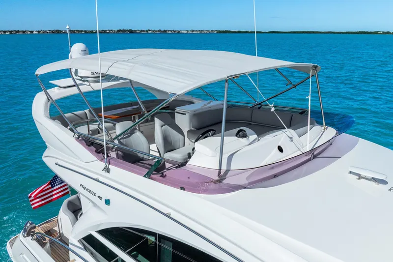 Slide: The Image of Luxury 2018 Princess F49 yacht with canopy, cruising on clear blue waters. - 17