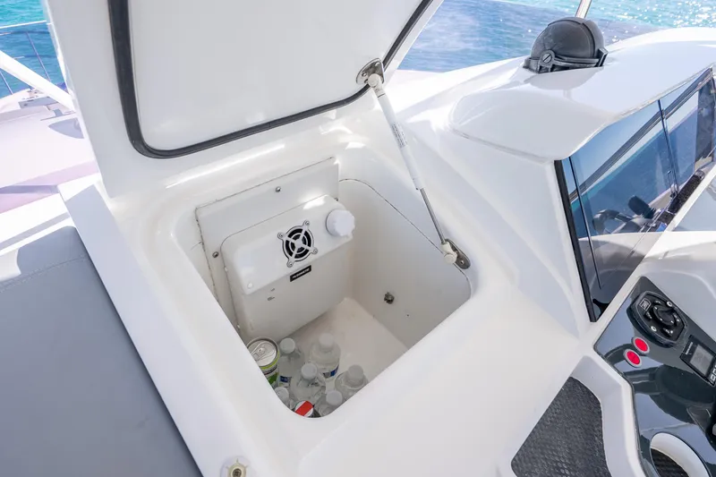Slide: The Image of Open storage compartment on 2018 Princess F49 yacht with drinks and ventilation fan. - 53