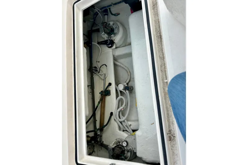 Slide: The Image of Engine compartment of a 2005 Bertram 390 Convertible boat, showing mechanical components and wiring. - 14