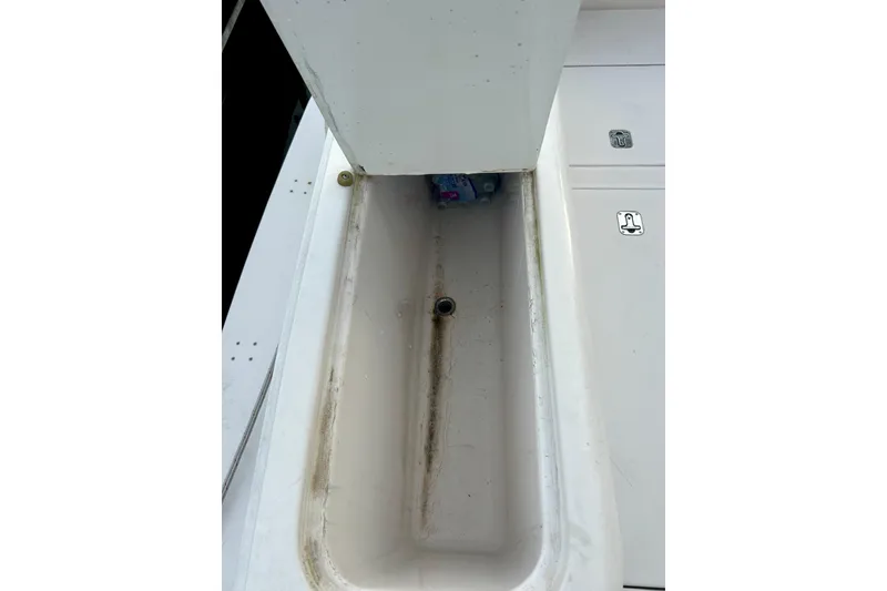 Slide: The Image of 2005 Bertram 390 Convertible boat storage compartment with drain plug. - 15