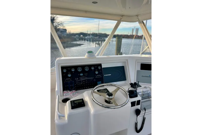 Slide: The Image of Helm of 2005 Bertram 390 Convertible with navigation equipment, overlooking marina. - 16