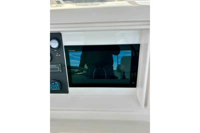 Slide: The Image of Control panel of a 2005 Bertram 390 Convertible boat with display screen. - 18