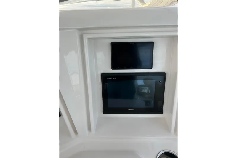 Slide: The Image of Garmin displays on 2005 Bertram 390 Convertible boat dashboard. - 19