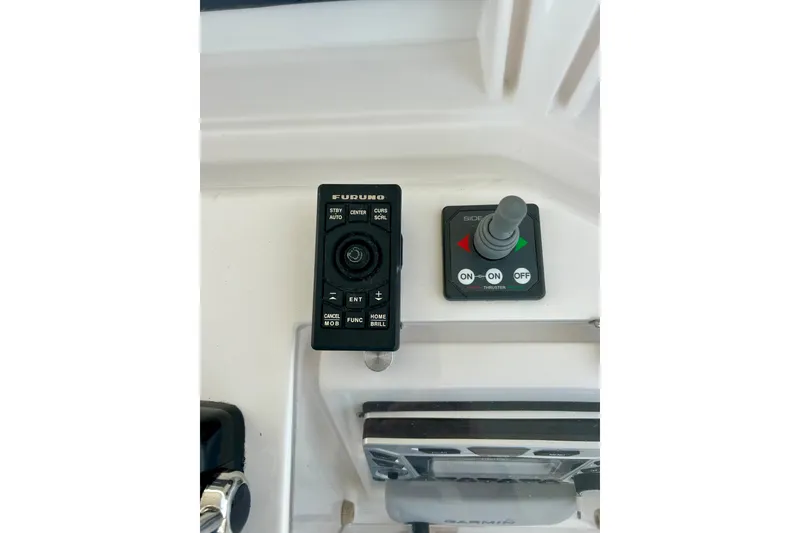 Slide: The Image of Control panel of a 2005 Bertram 390 Convertible boat with Furuno and Side-Power systems. - 22