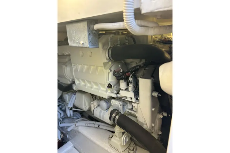 Slide: The Image of Engine compartment of a 2005 Bertram 390 Convertible boat, showcasing mechanical components. - 26