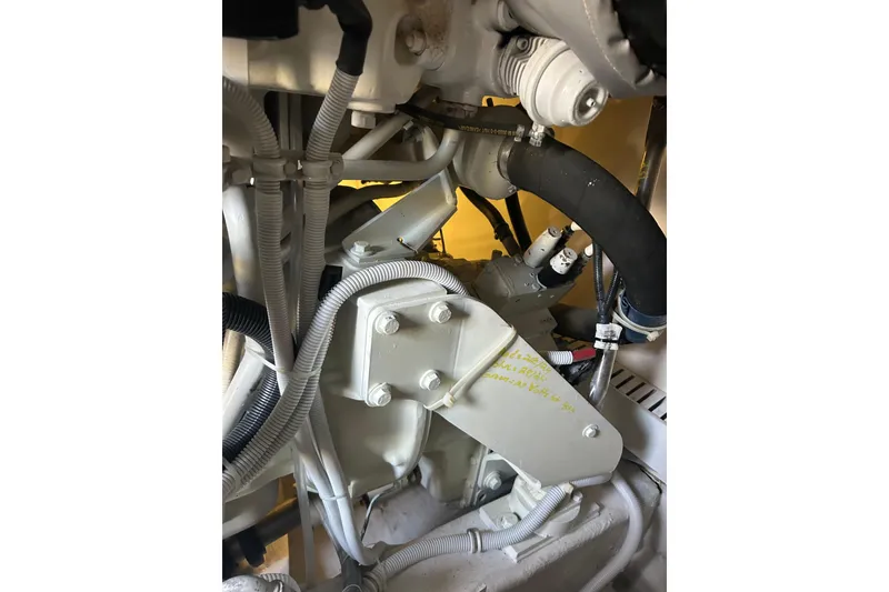 Slide: The Image of Engine components of a 2005 Bertram 390 Convertible boat, featuring hoses and wiring. - 27