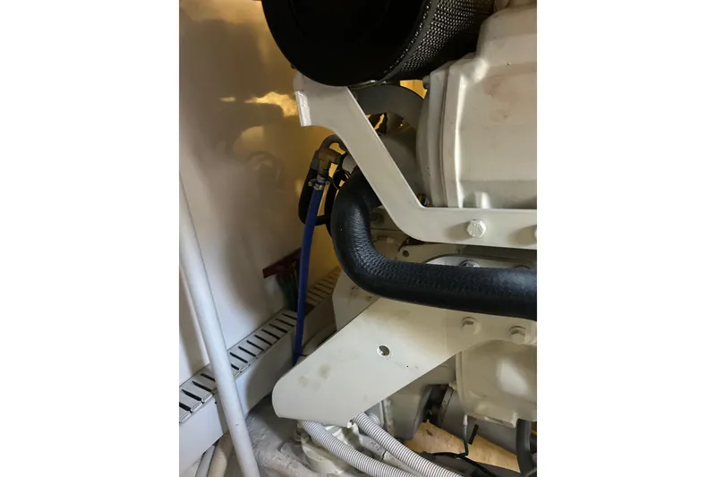 Slide: The Image of Engine compartment of 2005 Bertram 390 Convertible with visible hoses and components. - 28