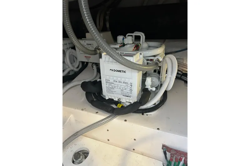 Slide: The Image of Dometic unit in 2005 Bertram 390 Convertible engine room with hoses and wiring. - 29