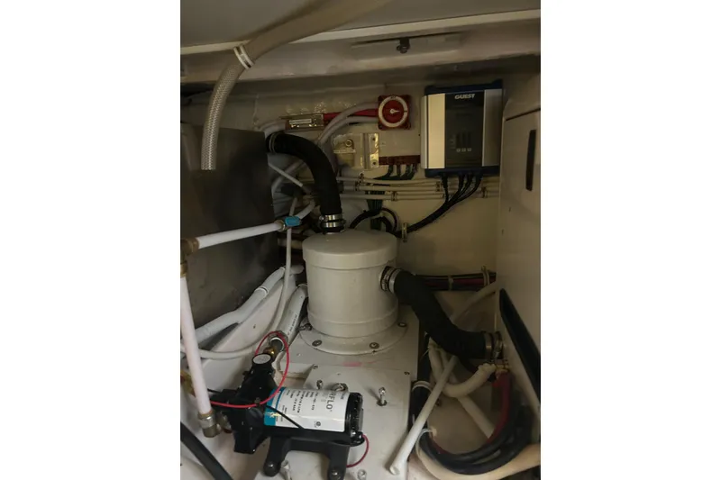 Slide: The Image of Engine room of 2005 Bertram 390 Convertible boat, showcasing mechanical components and wiring. - 31