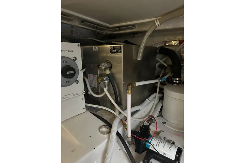Slide: The Image of Engine room of 2005 Bertram 390 Convertible with battery main switch and plumbing. - 32