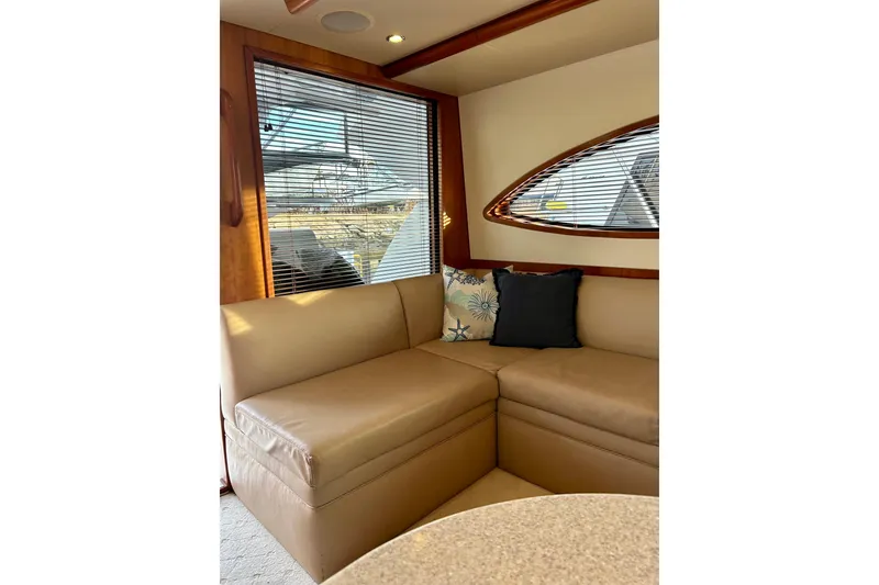 Slide: The Image of Luxurious interior of 2005 Bertram 390 Convertible yacht with beige seating and decorative pillows. - 37