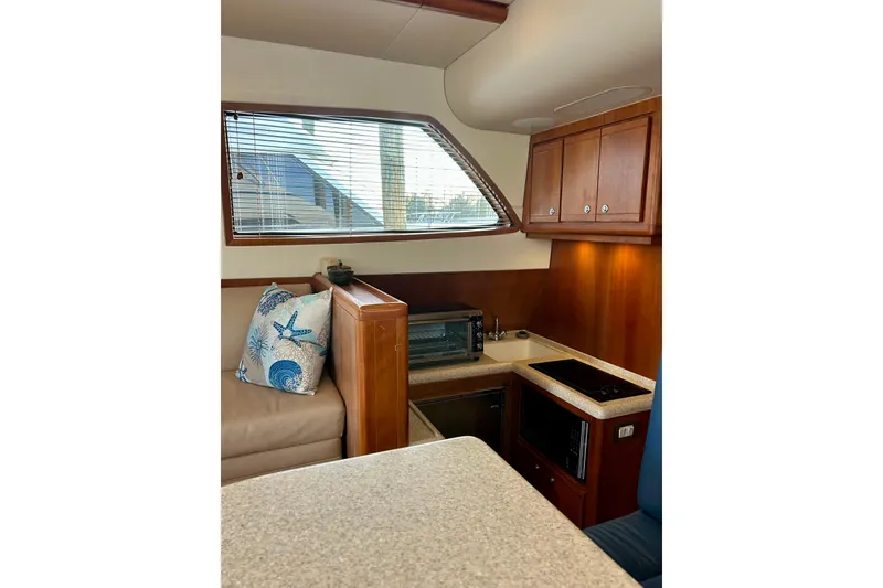 Slide: The Image of Interior of 2005 Bertram 390 Convertible yacht with kitchen and seating area. - 39
