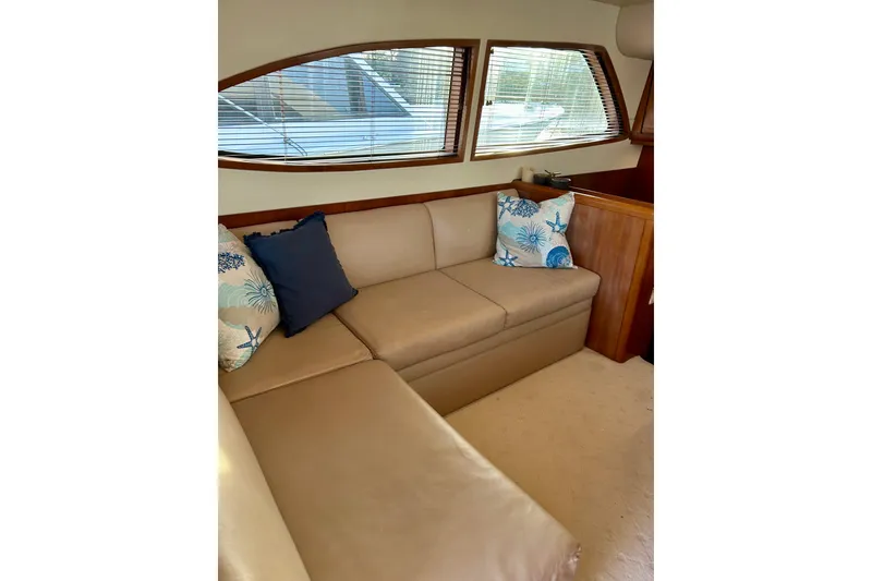 Slide: The Image of Interior of 2005 Bertram 390 Convertible with beige leather seating and decorative pillows. - 41
