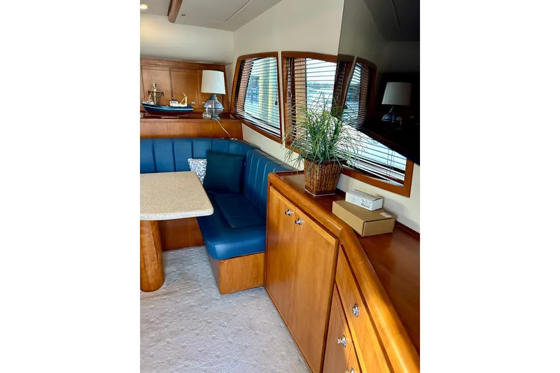 Slide: The Image of Interior of 2005 Bertram 390 Convertible yacht with blue seating and wooden cabinetry. - 43