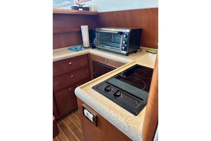 Slide: The Image of 2005 Bertram 390 Convertible yacht kitchen with stove and toaster oven. - 46