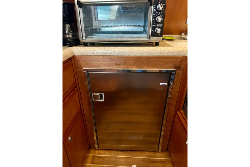 Slide: The Image of Stainless steel fridge and toaster oven in 2005 Bertram 390 Convertible yacht kitchen. - 51