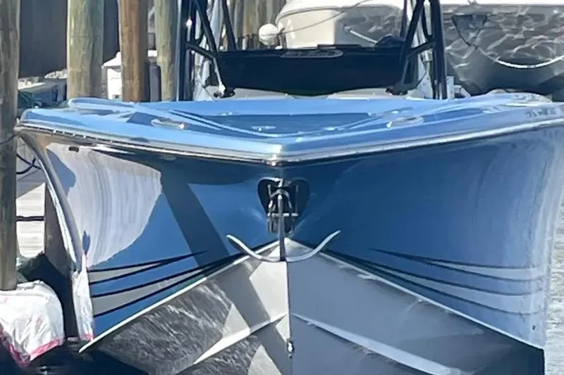 Slide: The Image of 2021 Nor-Tech 390 Sport Center Console boat docked, showcasing sleek blue hull design. - 11