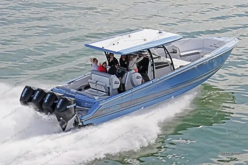 Slide: The Image of 2021 Nor-Tech 390 Sport Center Console cruising on water with passengers. - 5
