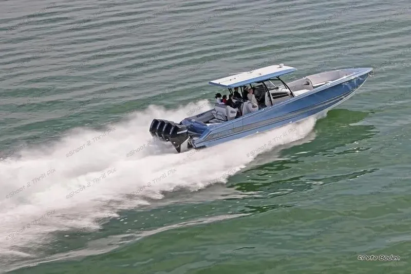 Slide: The Image of 2021 Nor-Tech 390 Sport Center Console speeding on water, showcasing sleek design and powerful engines. - 6