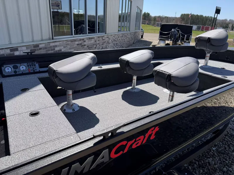 Slide: The Image of 2026 Alumacraft CLASSIC 165/TIL boat with four seats outdoors. - 5