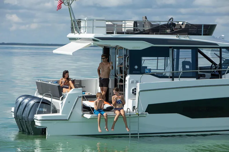 Slide: The Image of 2024 Jeanneau NC 1295 Fly yacht docked, showcasing sleek design and modern features. - 10