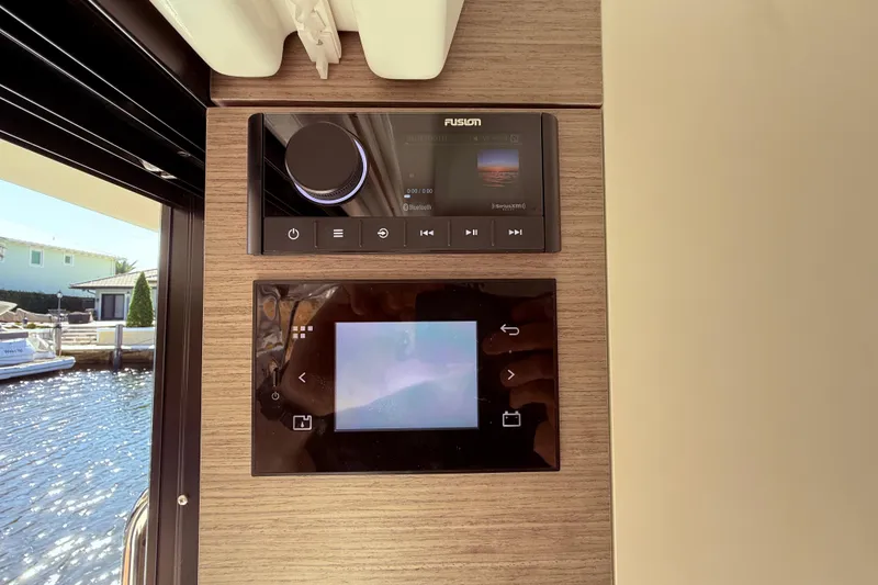 Slide: The Image of Control panel on 2024 Jeanneau NC 1295 Fly yacht, featuring Fusion audio system. - 14