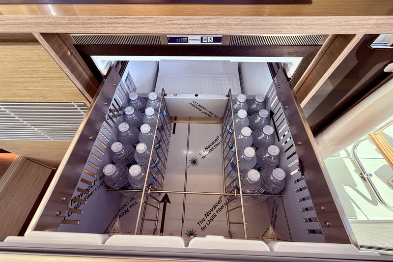 Slide: The Image of Open drawer fridge with water bottles on Jeanneau NC 1295 Fly, 2024 model. - 20