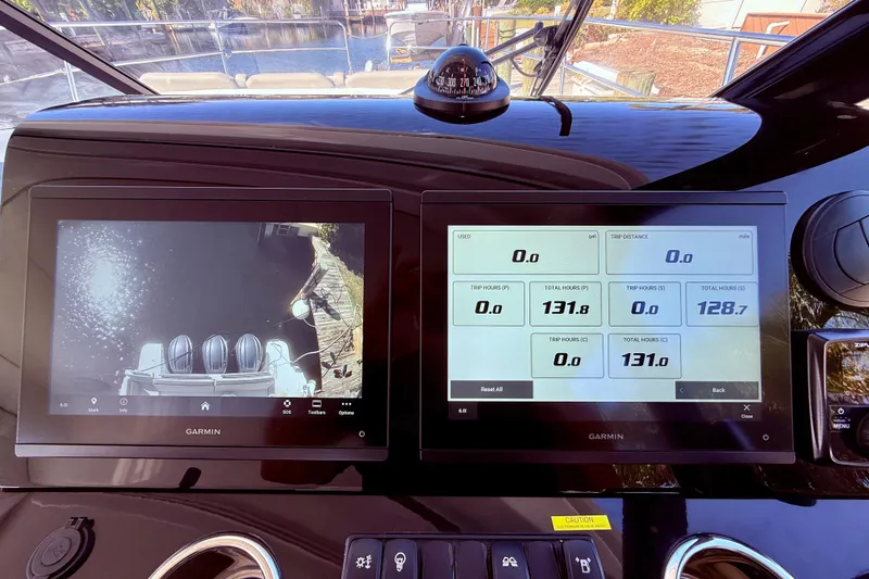 Slide: The Image of 2024 Jeanneau NC 1295 Fly cockpit with Garmin displays showing navigation and engine data. - 22