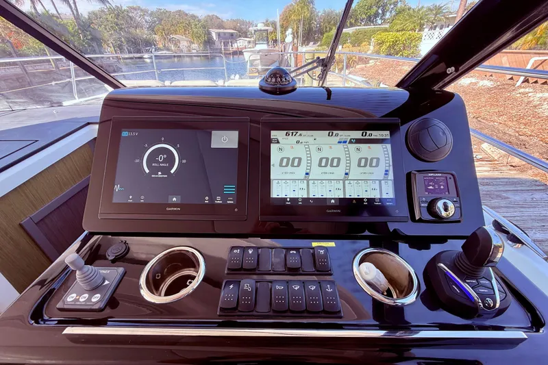 Slide: The Image of 2024 Jeanneau NC 1295 Fly cockpit with advanced navigation displays and controls. - 24