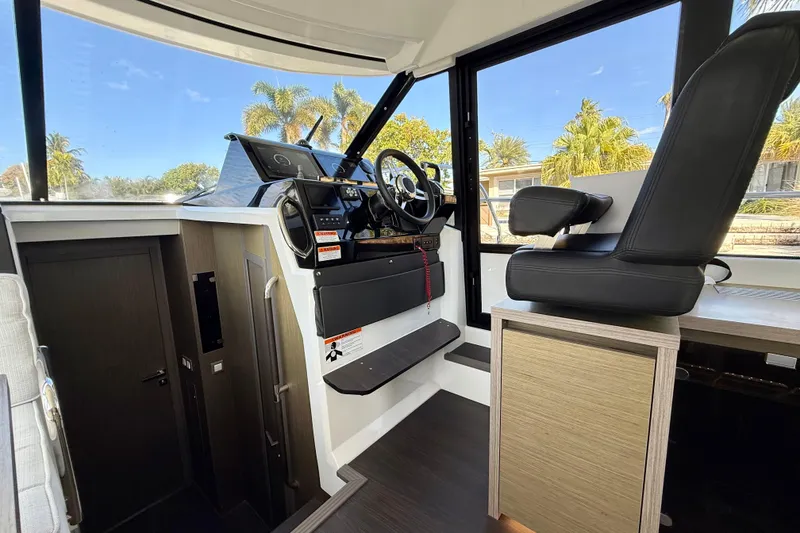 Slide: The Image of 2024 Jeanneau NC 1295 Fly cockpit with modern controls and comfortable seating. - 26