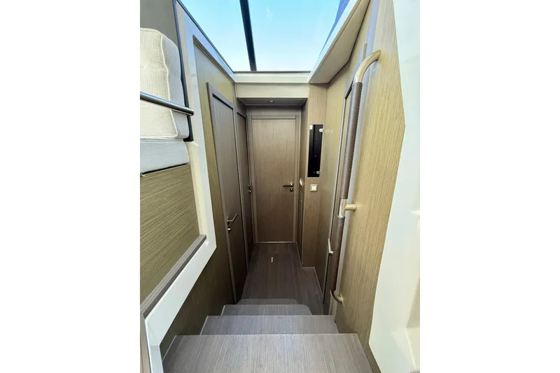 Slide: The Image of Interior of 2024 Jeanneau NC 1295 Fly, featuring modern wood paneling and sleek design. - 28