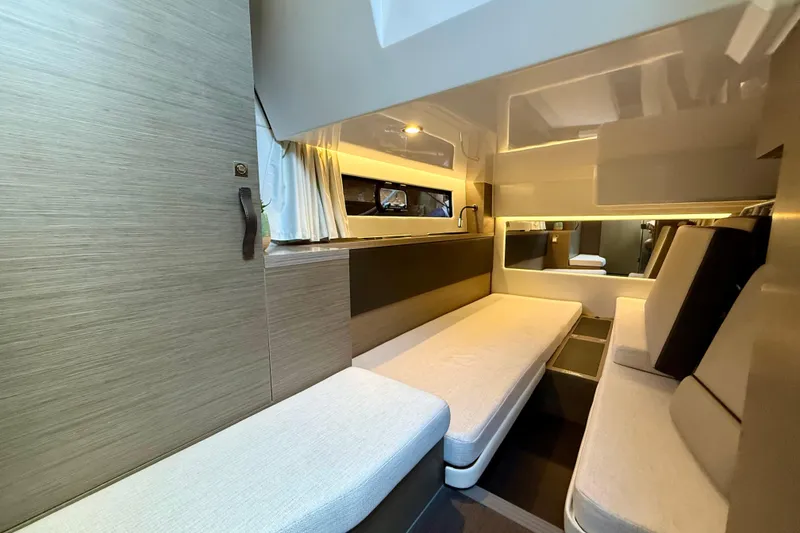 Slide: The Image of 2024 Jeanneau NC 1295 Fly interior cabin with modern seating and ambient lighting. - 29