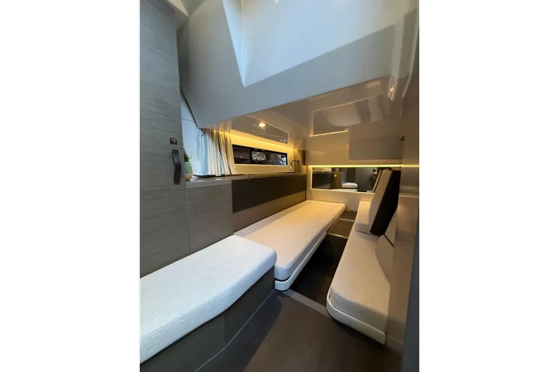 Slide: The Image of 2024 Jeanneau NC 1295 Fly interior cabin with modern seating and ambient lighting. - 30