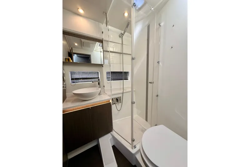 Slide: The Image of Modern bathroom in 2024 Jeanneau NC 1295 Fly yacht with sleek fixtures and glass shower. - 32