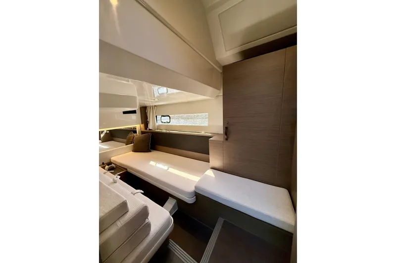 Slide: The Image of 2024 Jeanneau NC 1295 Fly interior cabin with modern seating and natural light. - 33