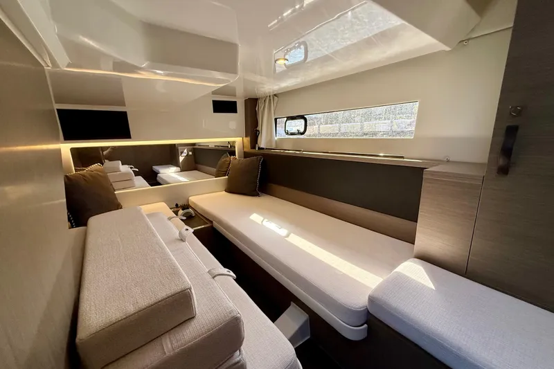 Slide: The Image of Luxurious interior of 2024 Jeanneau NC 1295 Fly yacht with modern seating and natural light. - 34