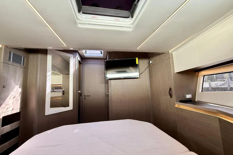 Slide: The Image of 2024 Jeanneau NC 1295 Fly cabin interior with modern design and natural lighting. - 37