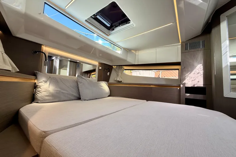 Slide: The Image of 2024 Jeanneau NC 1295 Fly cabin interior with modern design and natural lighting. - 42