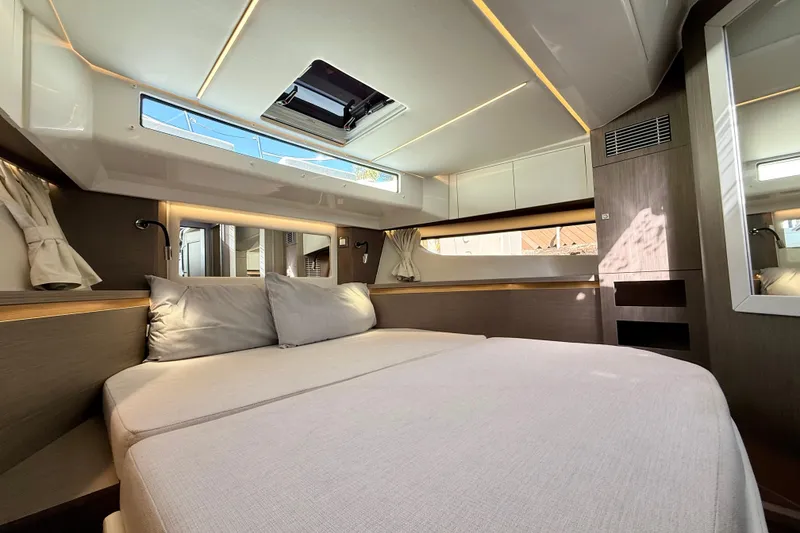 Slide: The Image of Luxurious interior cabin of 2024 Jeanneau NC 1295 Fly yacht, featuring modern design and comfortable bedding. - 43